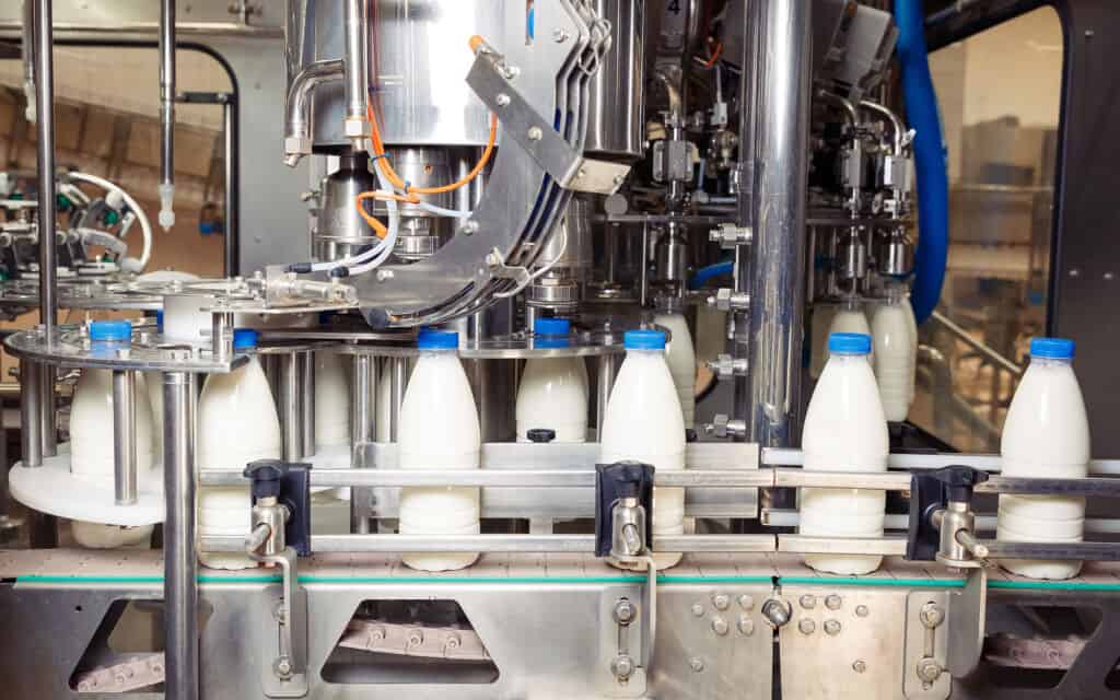 Side view of milk being packaged at a factory